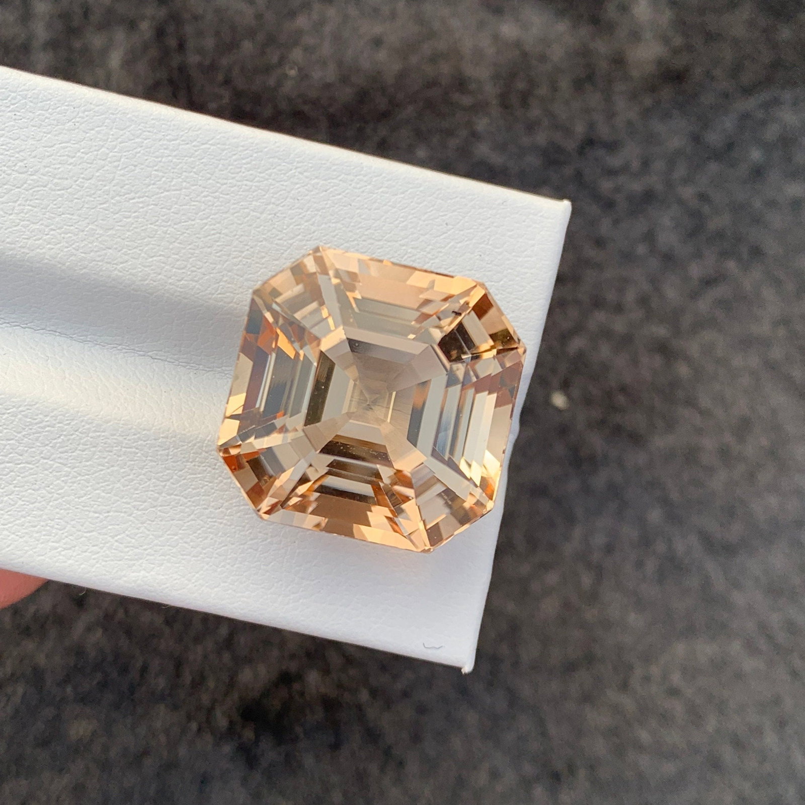 Sherry Topaz Gemstone: 46.55 CT Asscher Cut, Loupe Clean: Title: Sherry Topaz Gemstone: 46.55 CT Asscher Cut, Loupe Clean Description: Gemstone: Topaz Carat weight: 46.55 Discover the mesmerizing allure of our Sherry Color Topaz Gemstone, a radiant masterpie