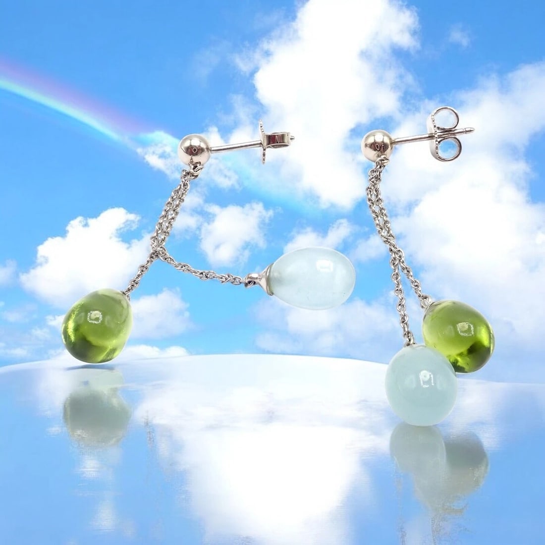Authentic! Tiffany & Co 18k White Gold Rainbow Drop Peridot Chalcedony Earrings: Authentic Tiffany & Co. drop earrings in 18k white gold featuring vibrant green peridot and soft blue chalcedony teardrop gems. Elegant and playful, the delicate chain design offers graceful movement 