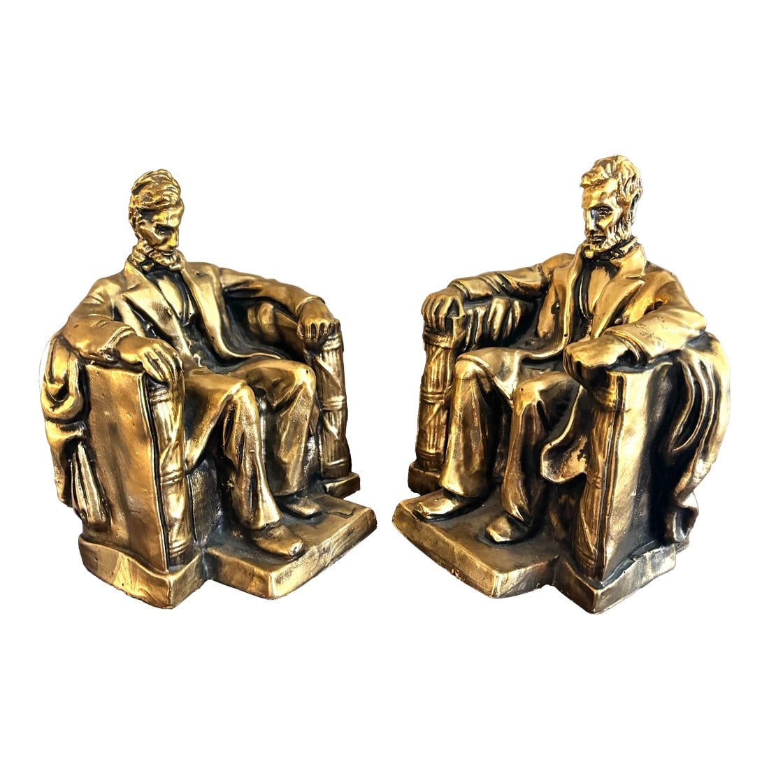 Mid-Century Americana Abraham Lincoln Plaster Bookends - a Pair: Featuring the 16th President of the United States, this substantial bookend pair depicts Lincoln sitting in a large chair., after the Lincoln Memorial in Washington DC. Surface is finished in gold rub