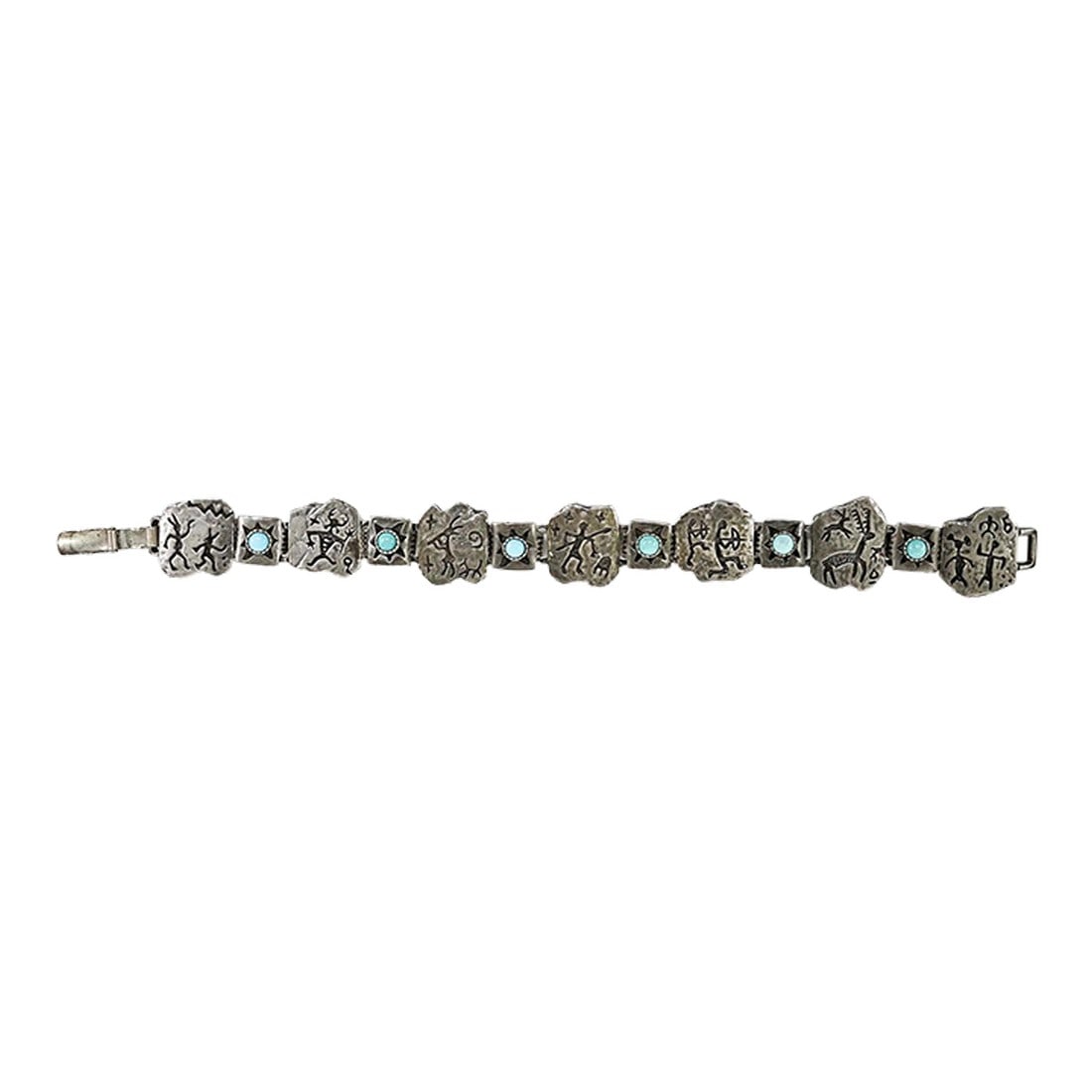 Late 20th Century Sterling Silver and Turquoise Link Bracelet: Late 20th century sterling silver and turquoise link bracelet. Marked sterling and with makers mark for Shube's Manufacturing Inc. Albuquerque. Each link is a cast rock art style figure with each