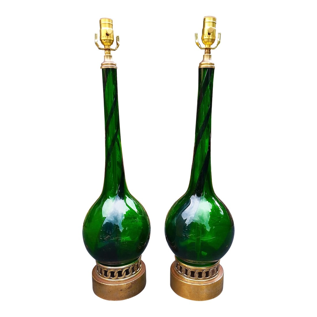 Pair of Restored Mid-Century Murano Attributed Glass Lamps – Emerald Green With Brass Bases: Striking pair of mid-century Murano glass lamps, handblown in a rich emerald green with elegant twisted necks and rounded gourd forms. Each lamp is mounted on an ornate, openwork brass base with a
