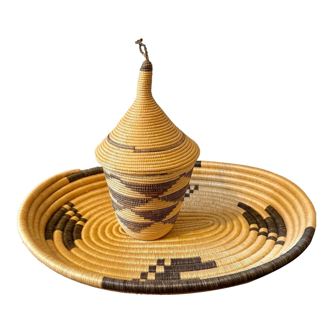 Set of 2, Rwandan Tutsi Woven Basket With Large Tray: Rwandan Tutsi handwoven baskets are known for their fine craftsmanship and tight stitches. They are symbolic of peace, unity and prosperity. This set features a beautifully crafted conical lidded