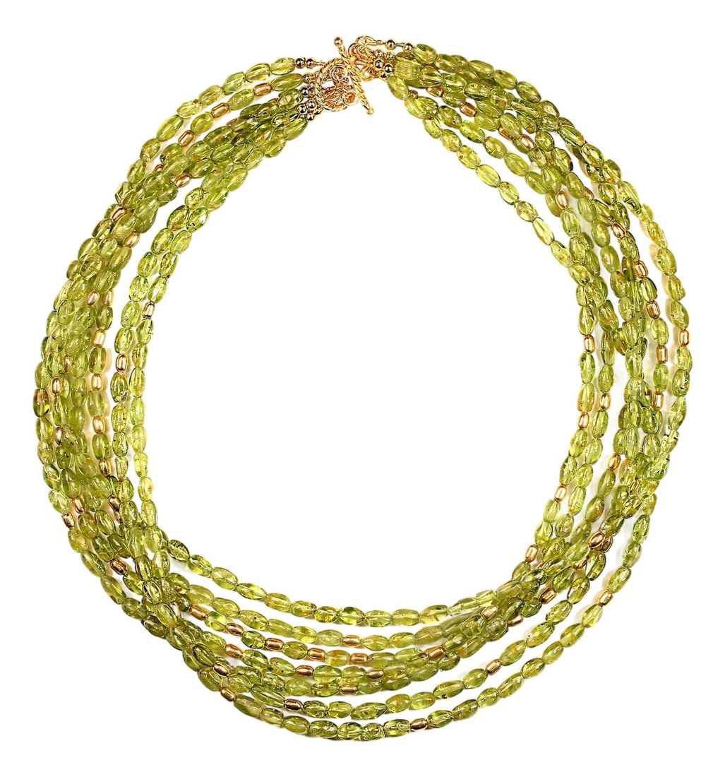 Gorgeous Multi Strand Peridot Necklace by Aria Jewelry Design August Birthstone: This handcrafted 18"‘inch peridot necklace brings together seven shimmering strands of smooth peridot tubes, creating a rich, layered look that feels both luxurious and effortless. Each strand