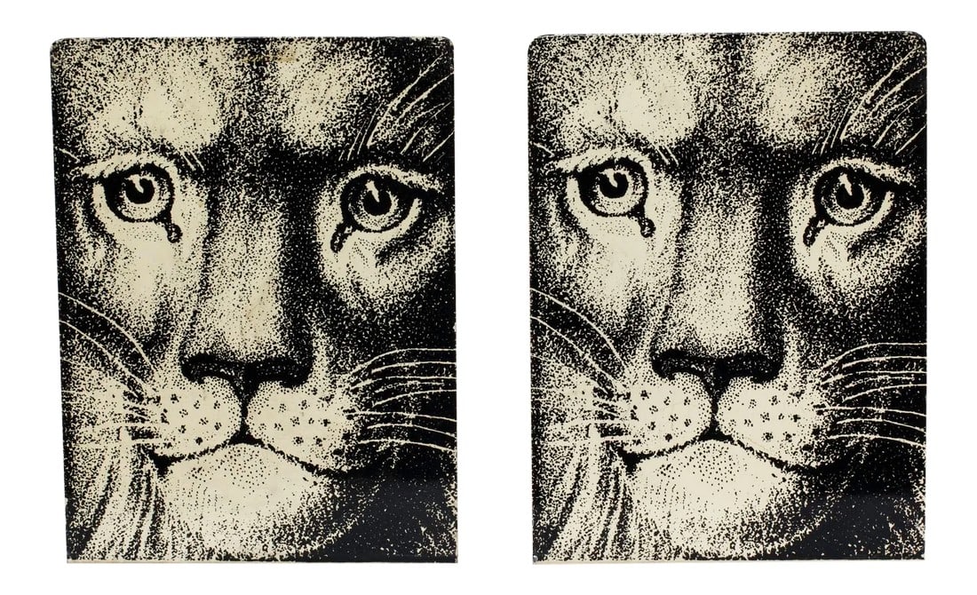 Fornasetti Enamel Lion Face Bookends - a Pair: Fornasetti Bookends signed in gold letters on red felt base. size 8" tall 5 3/4" wide foot 5 1/4" deep. Very collectable. Condition: Alterations: Original Condition Unaltered Imperfections: Some Imper