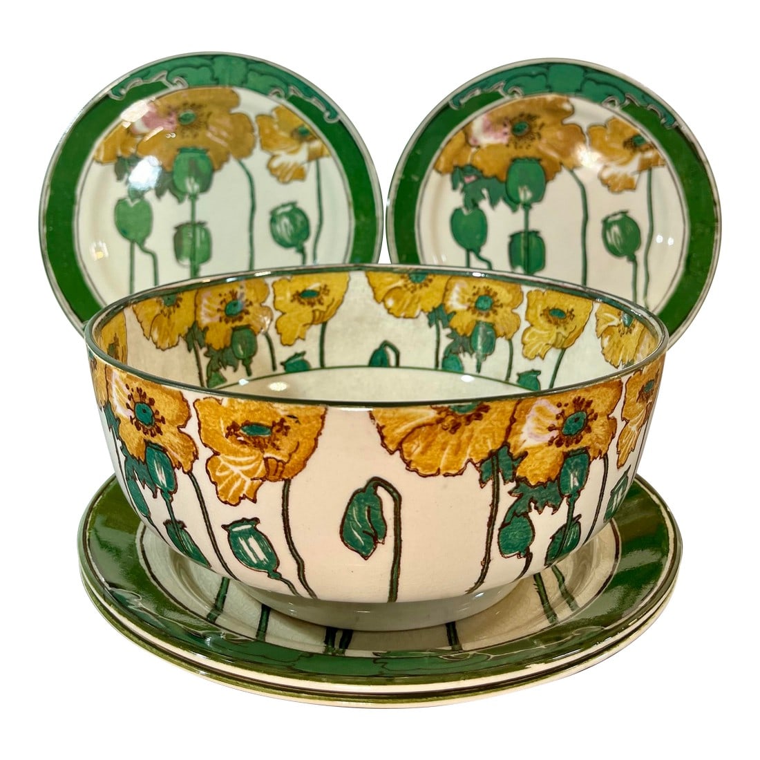 Antique Royal Doulton Poppy Footed Bowl & Plates - Set of 5: Early 20th Century Royal Doulton "Poppy" footed serving bowl and plates. White background with yellow poppies and green trim. Marked to underside. Bowl- 8"L x 3.5"H Plates- 8.75"L Condition: