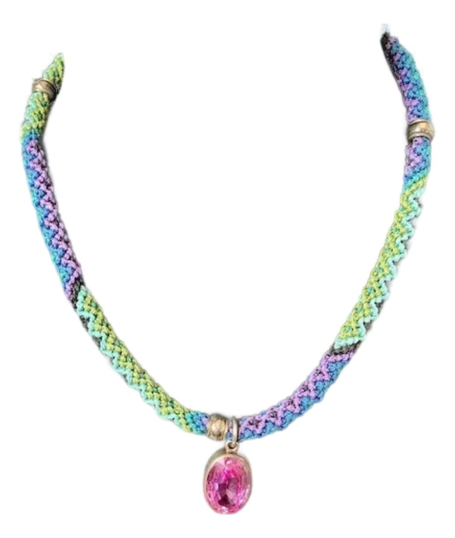 Sterling and Pink Stone Macrame Necklace: Unique and colorful macrame necklace with oval synthetic pink sapphire pendant. The large vibrant pink stone is set in sterling silver and hangs on a vibrant necklace of purple, green, blue and
