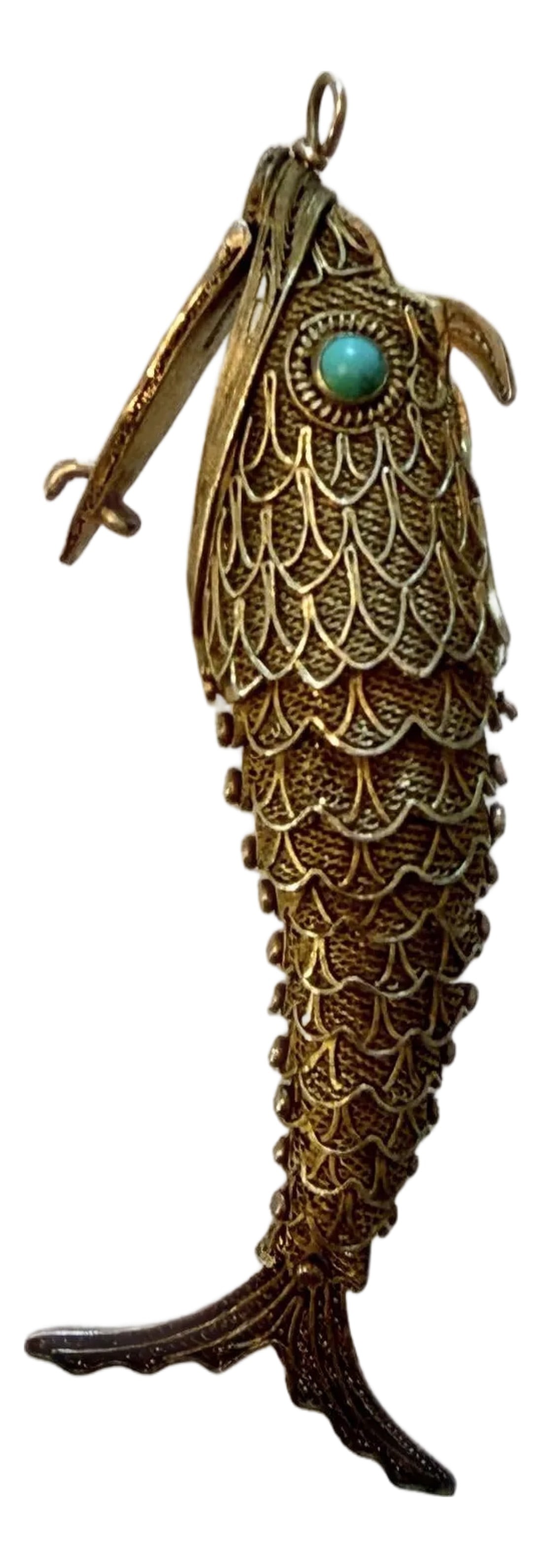 Antique Silver Articulated Koi Fish Pomander Pendant With Turquoise Eyes: Early 20th Century sterling silver filigree koi pendant with articulating body. Historically dating back to the Middle Ages, this unique style of pendant was used to hold aromatic spices or cotton