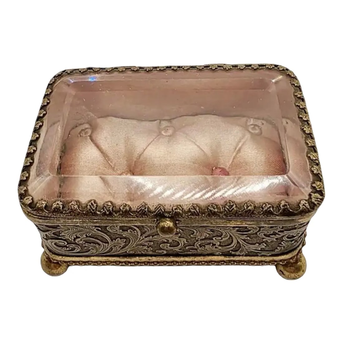 Antique French Ormolu Glass Jewelry Box With Original Tufted Coral Silk Interior: A darling antique French jewelry casket that preserves the elegance of a bygone era. This rectangular trinket box features beveled glass panels and ornate gold-toned ormolu sides, richly adorned with