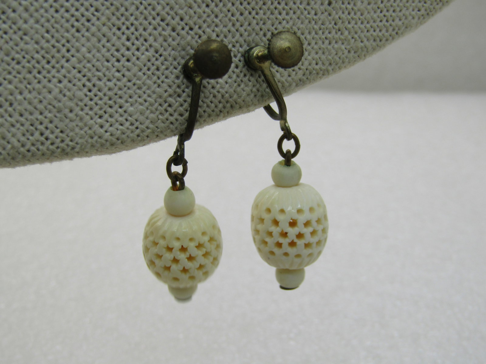 Vintage Carved Lantern Earrings, Screw Back, Mid-Century, 1.5": Vintage Carved Lantern Earrings, Screw Back, Mid-Century, 1.5". This has a cut-out lantern carved design, white. The carved portion is appx 11.5mm wide and 12.5mm tall with a 4.5mm bead on top and bot