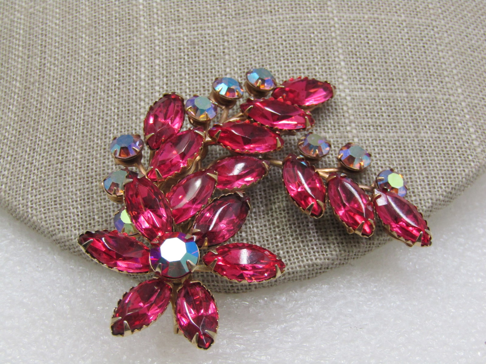 Vintage Pink & Blue A.B. Rhinestone Brooch, Mid-Century: Vintage Pink & Blue A.B. Rhinestone Brooch, Mid-Century, 2.5", gold tone. Blossom of pink rhinestones that are appx. 15mm by 10mm with a center 10mm round pink aurora borealis center. Two curved