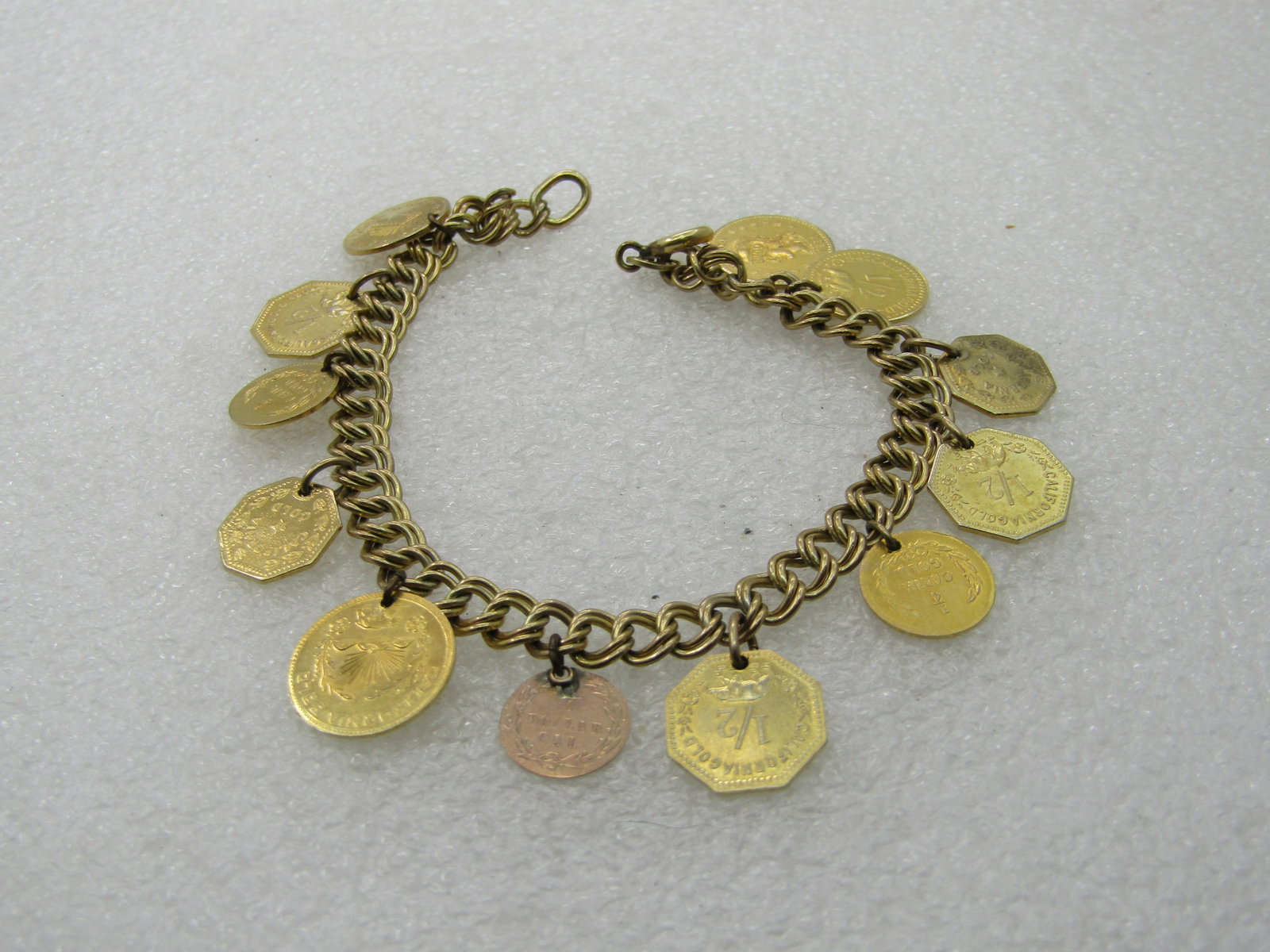 Vintage Gold Filled Replica Gold Coin Bracelet, Signed JB, 7": Vintage Gold Filled Replica Gold Coin Bracelet, Signed JB, 7", bracelt is a double link appx. 6mm wide, spring clasp. 12 coins appx. 1/2" . It is marked 1/20 12kt G.F and signed J.B. The coins are