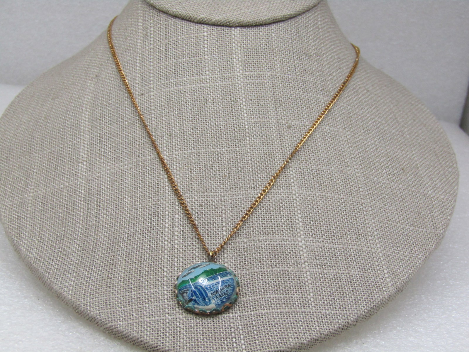 Vintage Niagra Falls Souvenier Necklace, 18", 1950's-1960's: Vintage Niagra Falls Souvenier Necklace, 18", 1950's-1960's. Green and blue domed design with the falls and trees in the background and white caps on the wa ter. It is bezel-set and appx. 3/4". The
