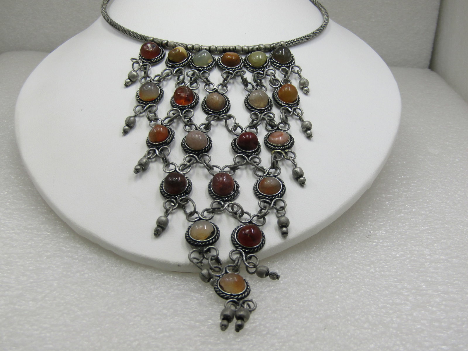 Vintage Coiled Collar Bib Necklace, 17", Stone 5" Drop: Vintage Coiled Collar Bib Necklace, 17", Stone 5" Drop with a mix of earthtone colored stones set in a rope accent frame with six stones at top tapered to a point with one stone at the bottom, silver 