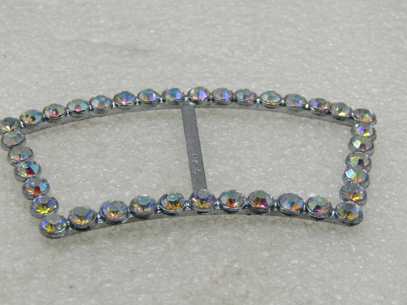 Vintage Curved Aurora Borealis Rhinestone Buckle, 1950's-1960's, 3": Vintage Curved Aurora Borealis Rhinestone Buckle, 1950's-1960's, 3" by 1.5". The rhinestones are appx. 3mm, all in place and original. Silver tone. Not signed by the maker. Very good condition. (INV.
