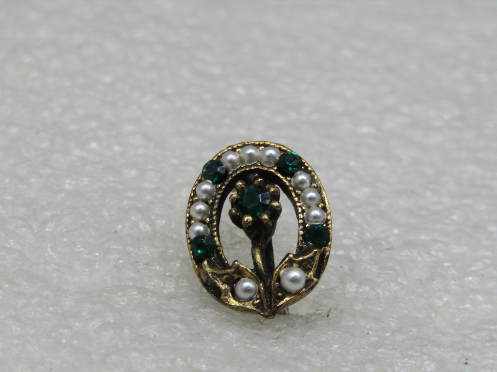 Vintage Petite Seed Pearl Rhinestone Floral Brooch: Vintage Petite Seed Pearl Rhinestone Floral Brooch, 1950's-1970's. This is a 5/8" tall oval with pen center that has seed pearls around the frame alternating with emerald green tone rhinestones and