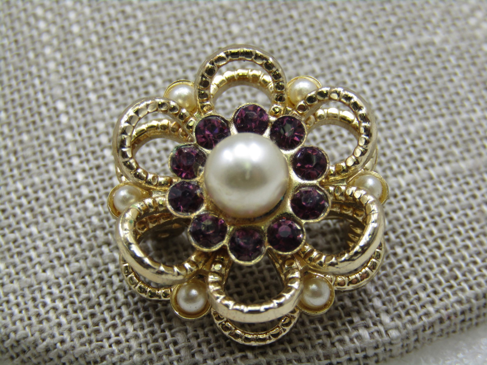 Vintage Faux Pearl Rhinestone Halo Brooch, 1", 1960's: Vintage Faux Pearl Rhinestone Halo Brooch, 1", 1960's. Gold tone with a textured petal desin in two tieres with faux seed pearls between the layers and on top there is a center 6.5mm pearl with a halo