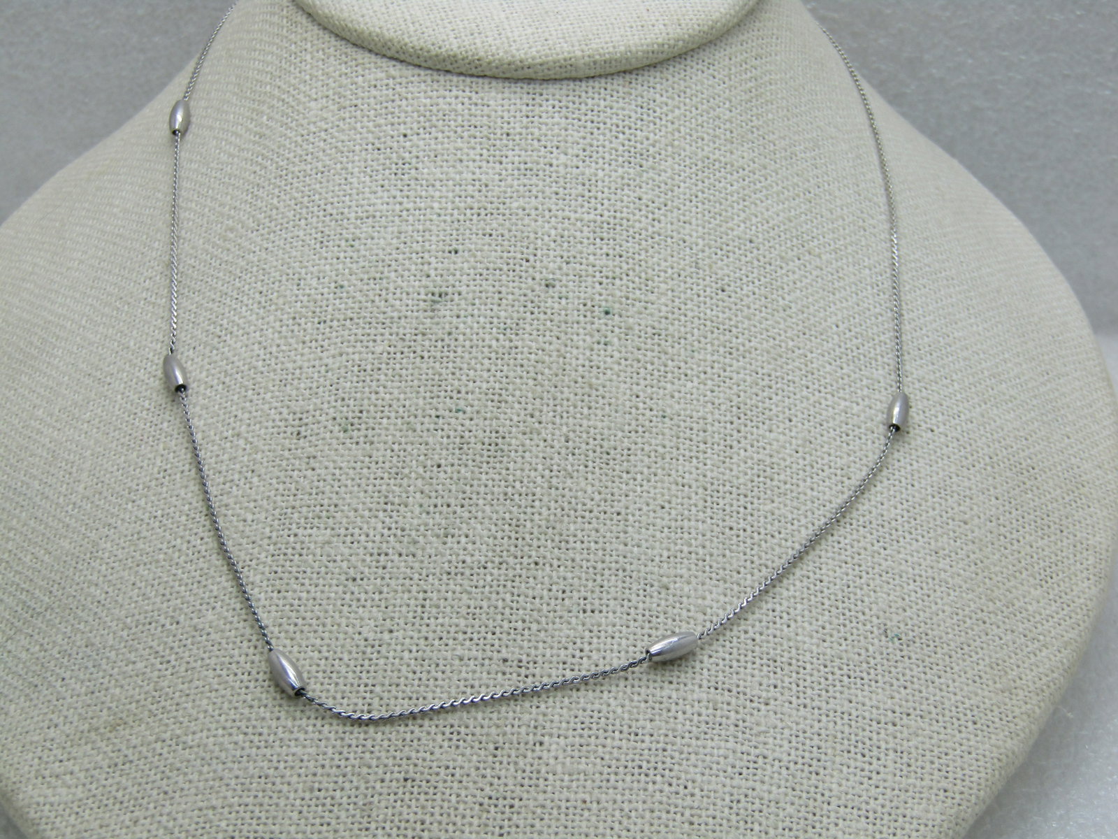 Vintage Avon Silver Tone Beaded Necklace, 17", Silver Tone: Vintage Avon Silver Tone Beaded Necklace, 17", Silver Tone, Post Mid-Century. Herringbone 1mm chain with oval 7mm oblong beads - five of them spaced at the front of the neck - very good condition.