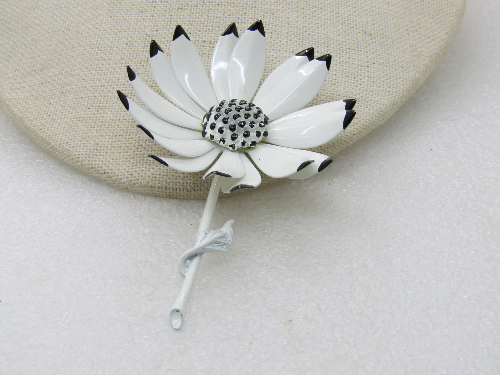 Vintage Black & White Enameled Floral Brooch, 2.5", 1960's: Vintage Black & White Enameled Floral Brooch, 2.5". Unsigned brooch with white enameled petals and black tips and a centered dotted textured raised area. Age is appx. 1960's. Back of the brooch is als