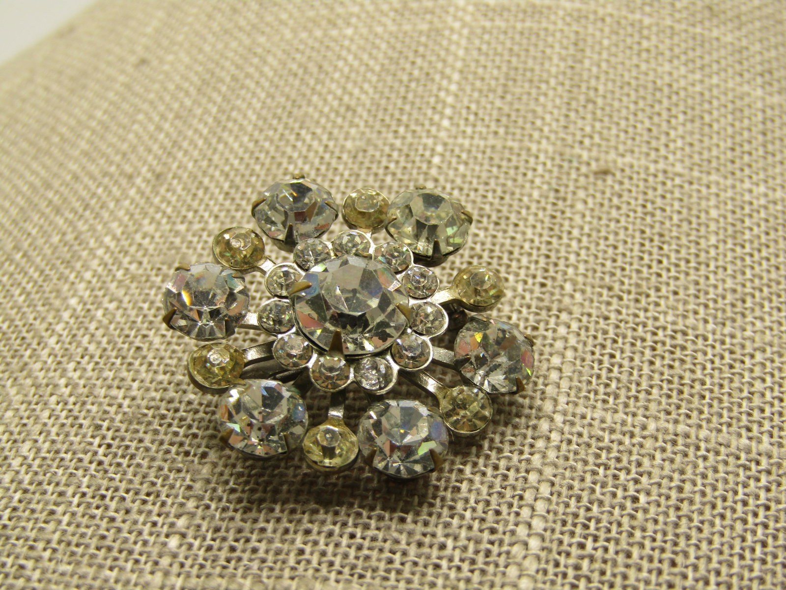 Vintage Clear Rhinestone Blossom Brooch, 1-1/8", 1940's: Vintage Clear Rhinestone Blossom Brooch, 1-1/8", 1940's, Silver tone tiered design with an 8mm stone in top cetner that has a halo of smaller 2.5mm stones and then a lower tear that is alternating