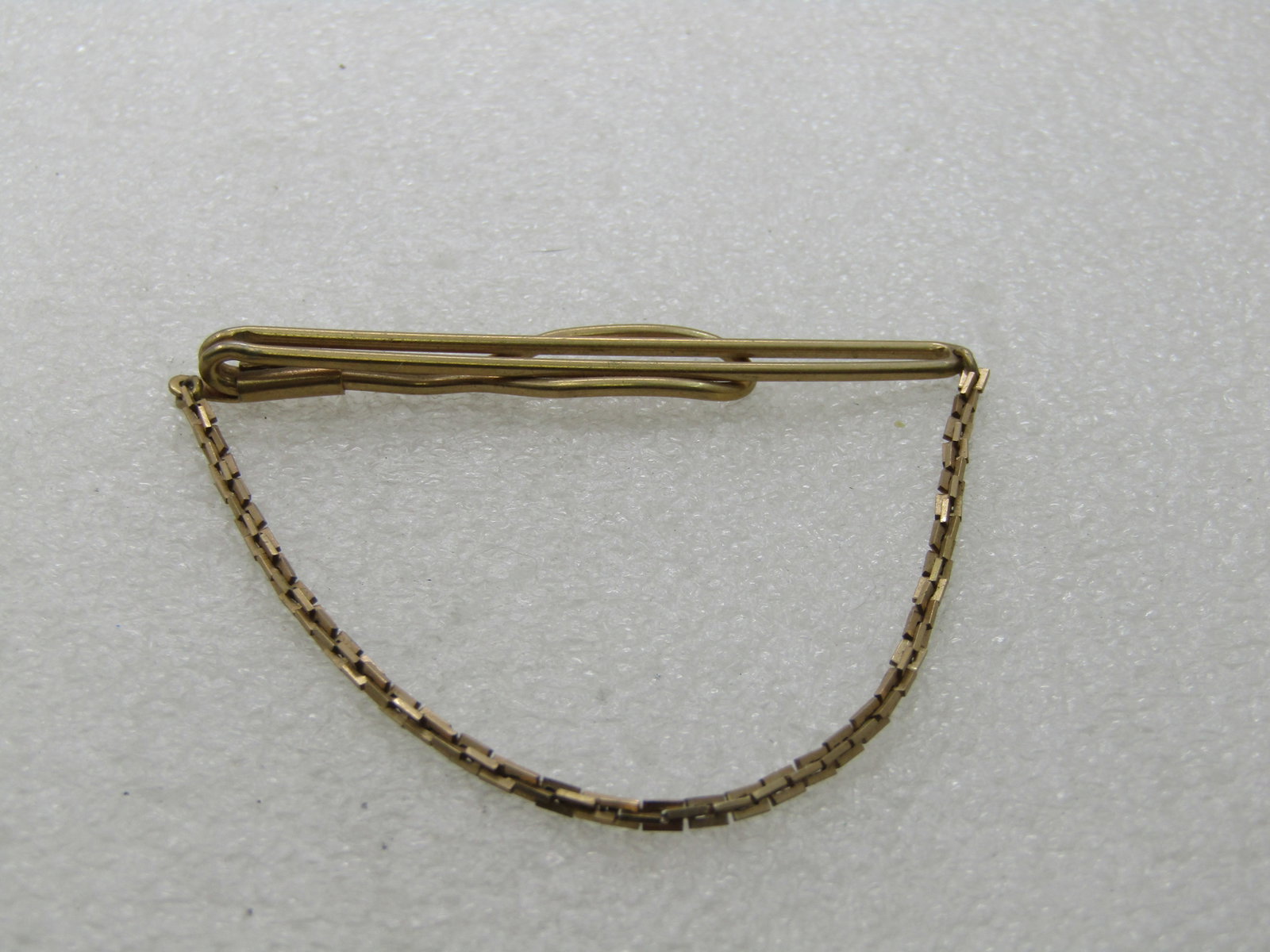 Vintage Swank Tie Bar with Chain, 1940's-1950's, Gold Tone: Vintage Swank Tie Bar with Chain, 1940's-1950's, Gold Tone, 2.5" wide and 2" drop. the chain link is made up of rectangular links that are connected and alternated in direction to created an appx.