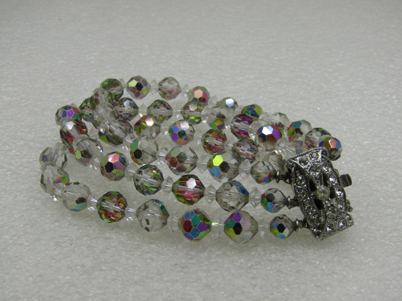 Vintage Aurora Borealis Crystal Bracelet, Triple Strand, 7.5": Vintage Aurora Borealis Crystal Bracelet,Triple Strand, 7.5" long and 1" wide, beautiful art deco rhinestone box clasp. Silver tone. The beds are clear with a purple and blue aurora borealis shimmer