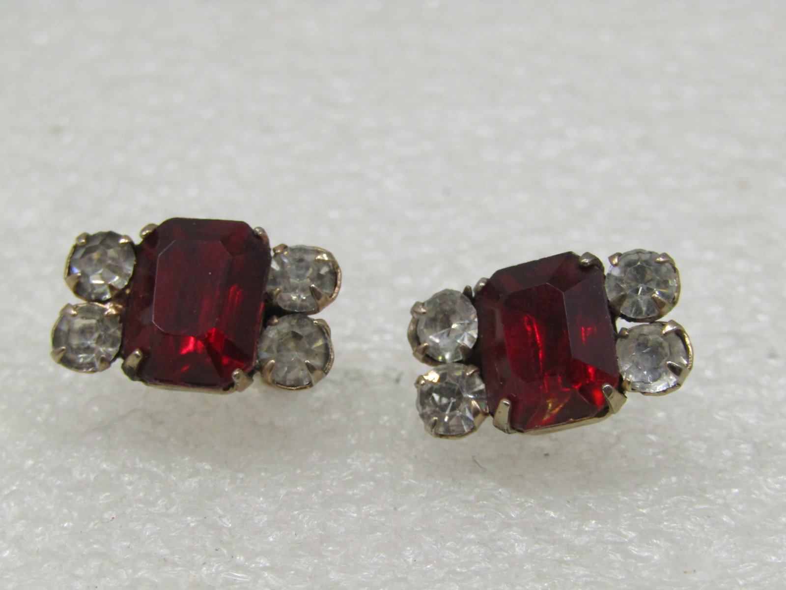 Vintage Red & Clear Rhinestone Earrings, Screwback, 1940's-1960's: Vintage Red & Clear Rhinestone Earrings, Screwback, 1940's-1960's. A large prince cut red rhinestone in the center that is appx. 10mm by 7.5mm and foru clear stones, two on each side that are appx.