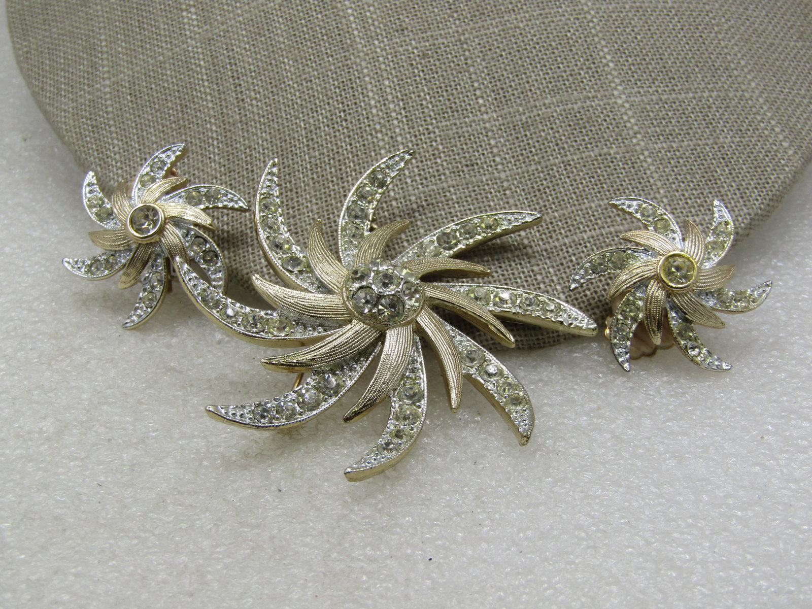 Vintage Rhinestone Brooch & Earrings Set, Spiral Starburst: Vintage Rhinestone Brooch & Earrings Set, Spiral Starburst Set, Signed Sarah Coventry. Earrings are clip. Pointed silver tone rays with pave set rhinestones and then a gold pointed shorter tier that