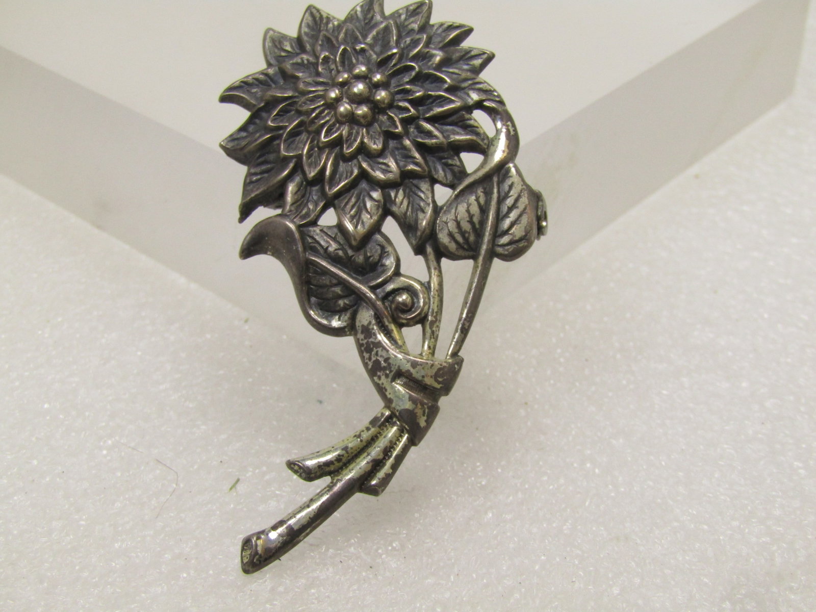 Vintage Sterling Floral Stem Brooch, 1940's: Vintage Sterling Floral Stem Brooch, 1940's. This has the look, to me, of a dahlia but could be a different flower. It has a single large blossom with curved stem and two leaves. It is appx. 2.75"
