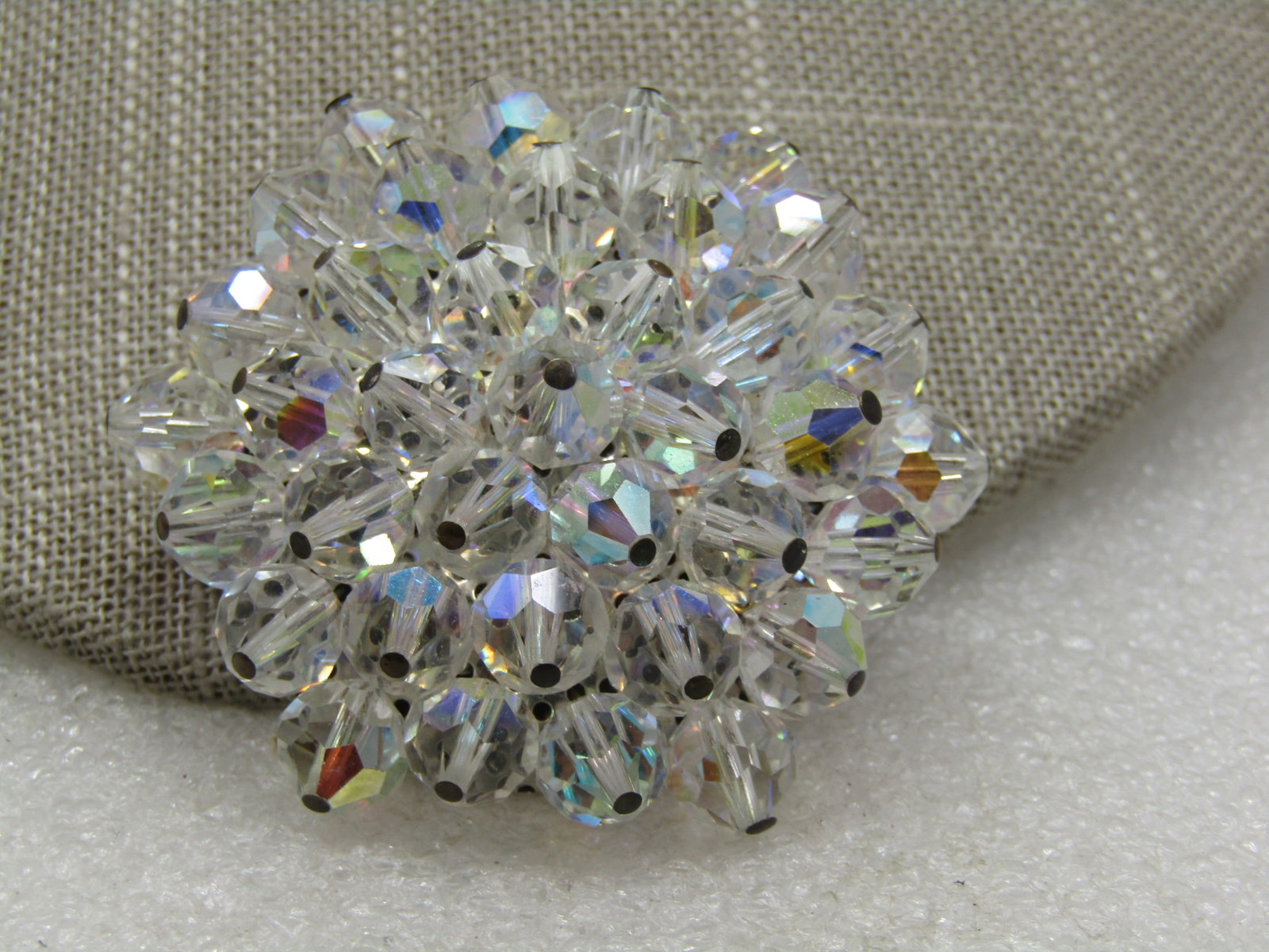 Vintage Aurora Borealis Crystal Brooch, 2", 1960's: Vintage Aurora Borealis Crystal Brooch, 2", 1960's. A cluster of faceted crystal beads that are attached to a base creating a blossom to star look with shmimering aurora borealis hues. Silver tone.