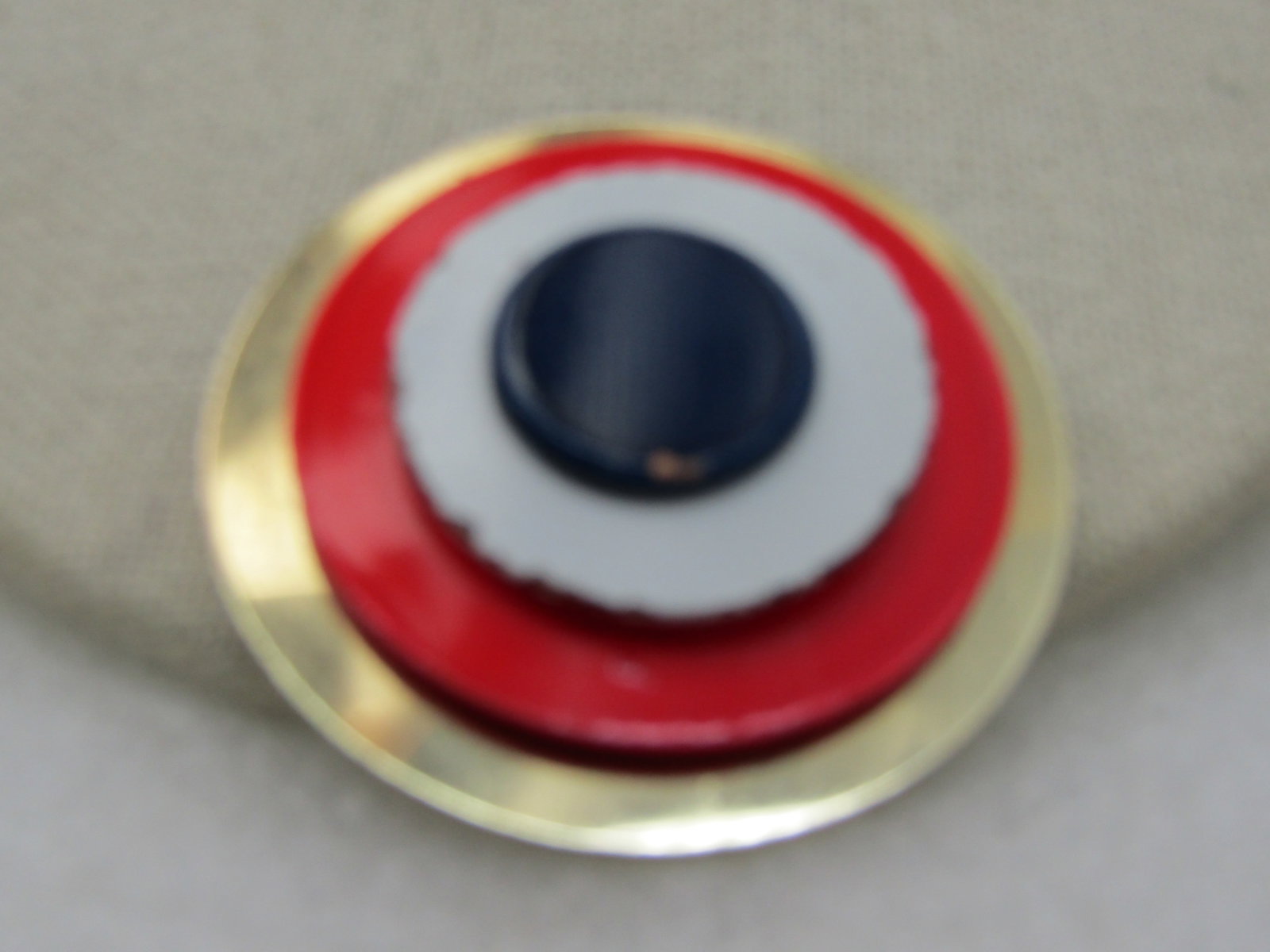 Vintage Gold Tone & Enameled Tiered Brooch, 1960's: Vintage Gold Tone & Enameled Tiered Brooch, 1960's, nearly 2" with four tieres. The widest is the bottom and is gold tone with an orange enameled shorter tier, white enameled, and then a top deep