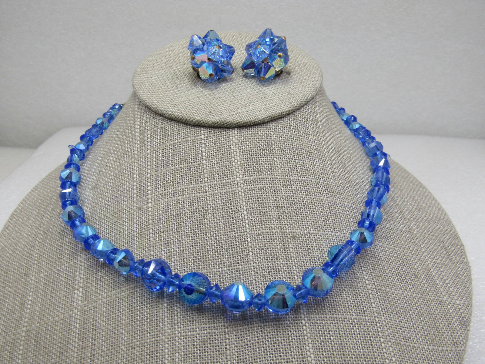 Vintage Blue Aurora Borealis Rhinestone Necklace & Clip Earrings: Vintage Blue Aurora Borealis Rhinestone Necklace & Clip Earrings, 16.5" necklace with hook clasp. Graduated beads from 6mm to 11mm. The rounded beads are interesting because their points are cut with 