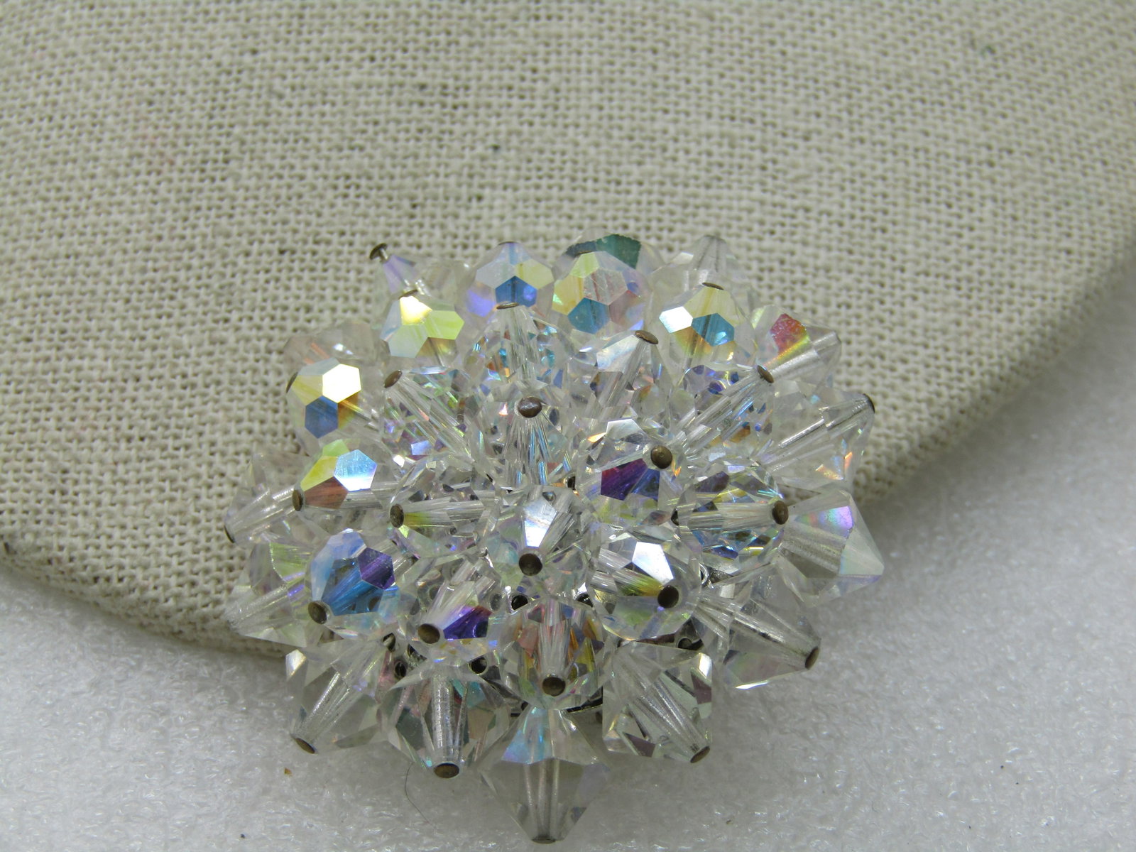 Vintage Aurora Borealis Crystal Brooch, 1.75": Vintage Aurora Borealis Crystal Brooch, 1.75", 1960's. It has crystals mounted on a silver tone base, pointed outward . Shimmering and clean. Very good condition. Not signed by the maker. (INV. W.1302