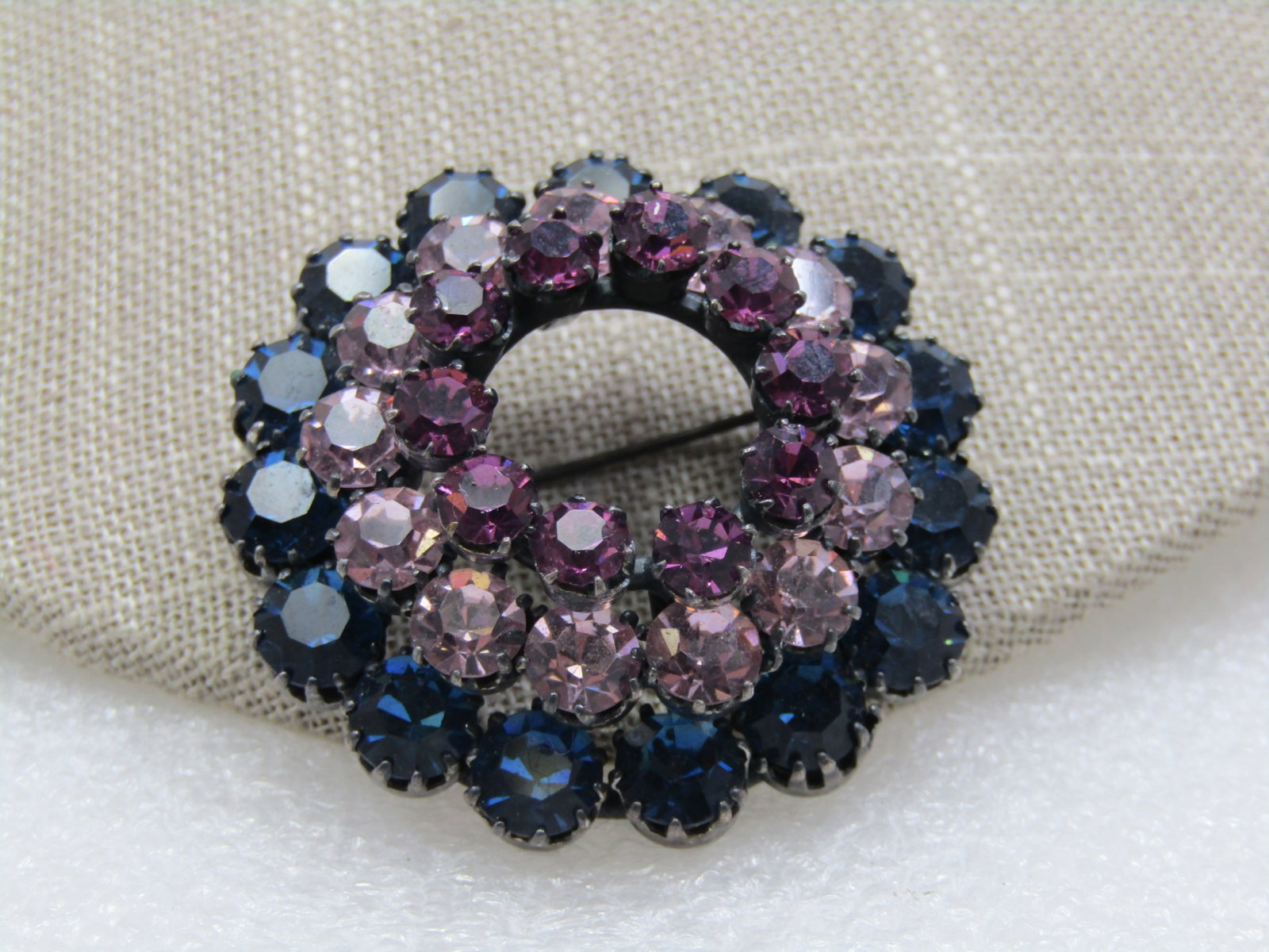 Vintage Austria Blue Purple Crystal Brooch, 1940's-1950's: Vintage Austria Blue Purple Crystal Brooch, 1940's-1950's, 1.5" across. Three tiers, the bottom are a dark blue crystal rhinestone that is appx. 7mm and prong set. The next layer up is a lavender
