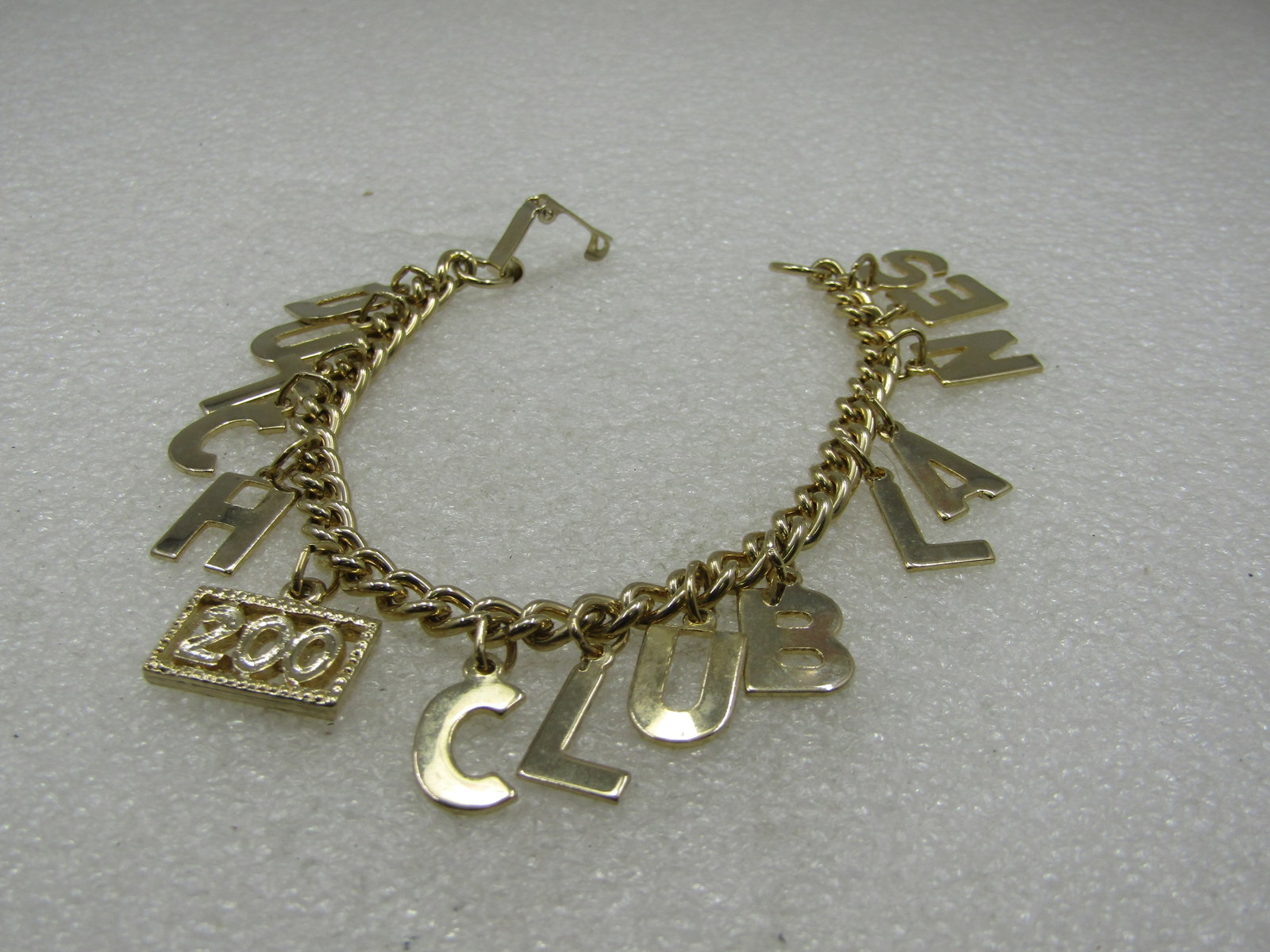 Vintage Dutch Lanes 200 Club Charm Bowling Bracelet, 7": Vintage Dutch Lanes 200 Club Charm Bowling Bracelet, 7". Letter charms spell out Dutch Club Lanes with a 200 rectangular charm. The letters dangle down appx. 3/4", 5mm wide curb link bracelet with
