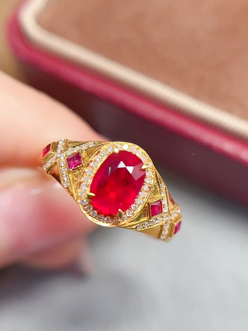 18K Gold Ruby Ring: Title: 18K Gold Ruby Ring Description: This ring is crafted in 18K gold, featuring a natural ruby with a rich pigeon blood hue, clean and flawless. The vintage design is beautifully integrated with mo