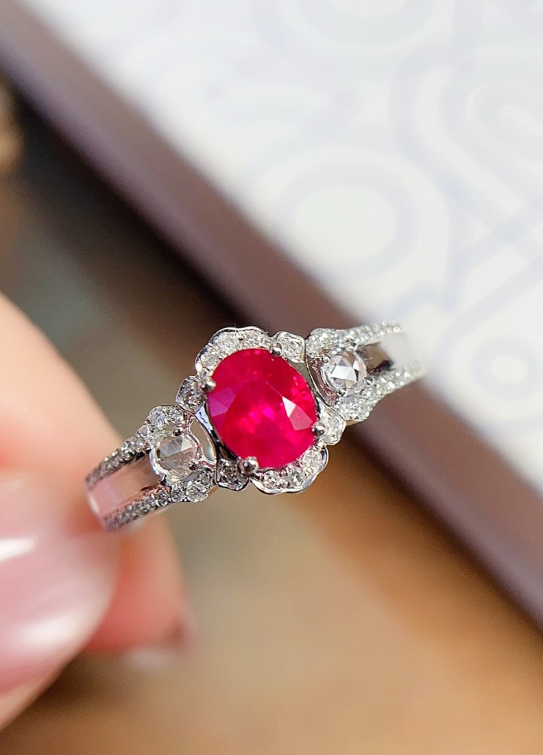 18K Gold Ruby Ring: Title: 18K Gold Ruby Ring Description: This ring is meticulously crafted in 18K gold, featuring a natural pigeon blood red ruby with a rich golden hue and cool white brilliance. The main stone is