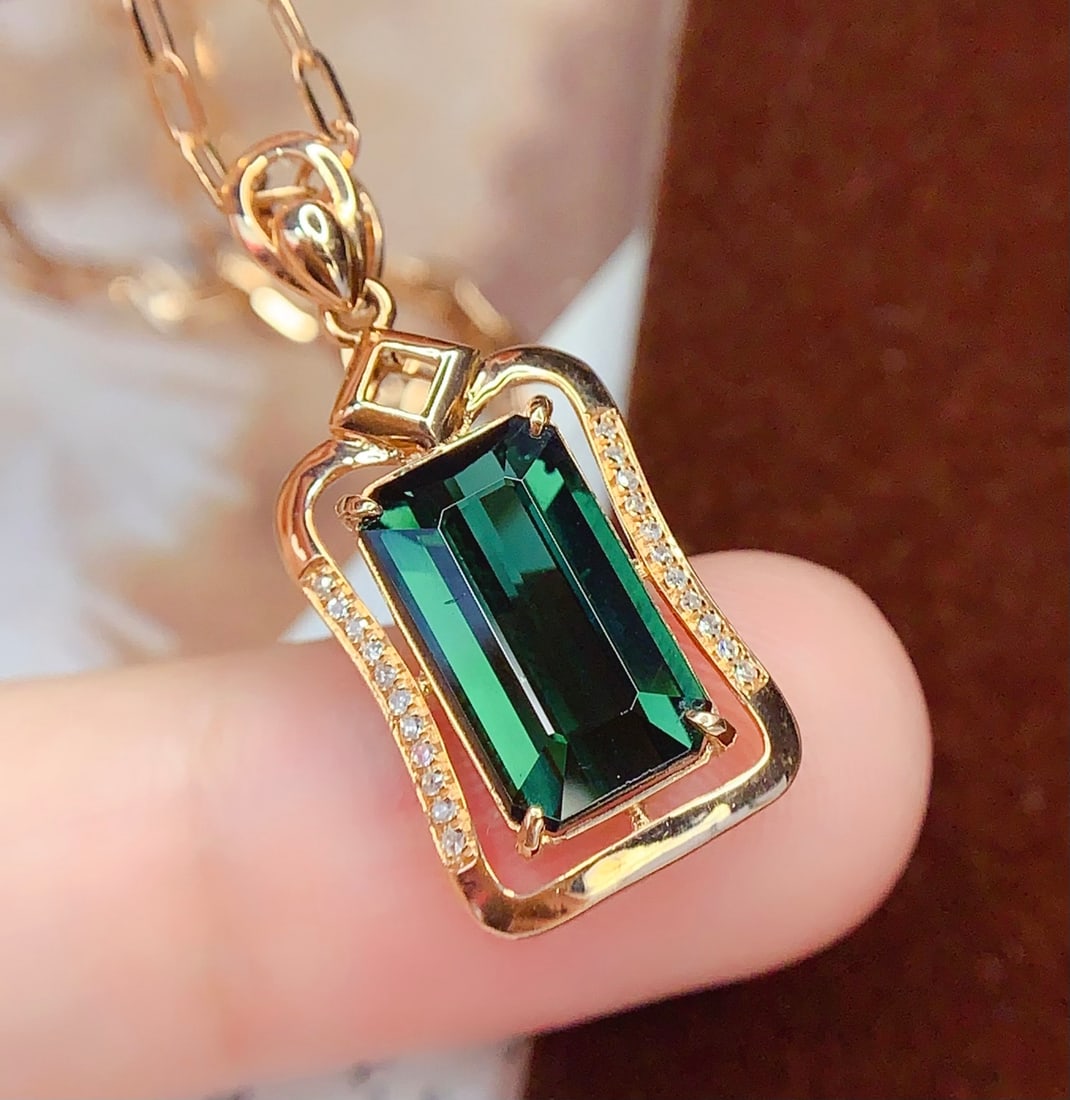 18K Gold Natural Tourmaline Pendant: Title: 18K Gold Natural Tourmaline Pendant Description: This pendant features a natural tourmaline as its centerpiece, showcasing a perfect blend of rich gold and cool white. The large-diameter tourma