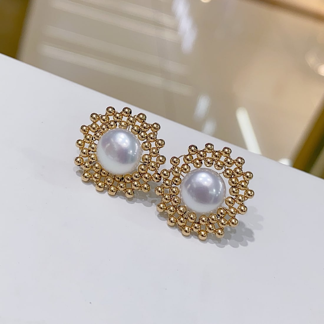 Natural freshwater pearl earrings: Title: Natural freshwater pearl earrings Description: Natural freshwater pearl earrings, displaying a rich golden hue and a cool white sheen. Each pearl is large in diameter, nearly flawless, round an