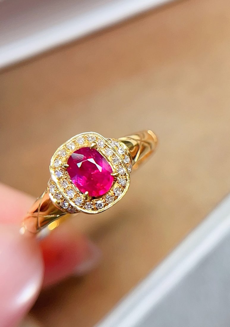 18K Gold Ruby Ring: Title: 18K Gold Ruby Ring Description: This 18K gold ruby ring features an unheated pigeon blood ruby with a glass-like luster, clean and crack-free. The vintage design is perfectly integrated with mo