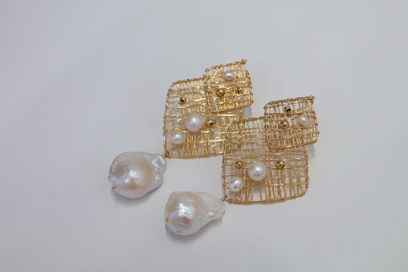 Natural Freshwater Baroque Pearl Earrings: Title: Natural Freshwater Baroque Pearl Earrings Description: These earrings are set with natural freshwater baroque pearls, each boasting a rich luster and unique shape. Each pearl has been