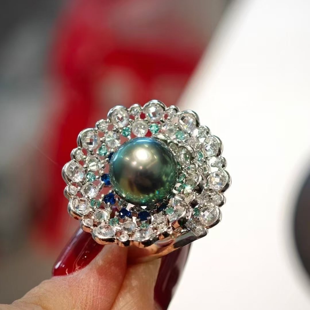 Sterling Silver Tahitian Black Pearl Ring: Title: Sterling Silver Tahitian Black Pearl Ring Description: Sterling Silver Tahitian Black Pearl Ring, each measuring 10-11mm in diameter, showcasing a flawless peacock green luster. Each pearl is