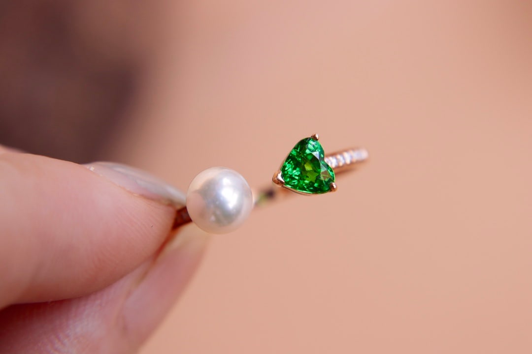 18K Gold Diamond and Pearl Ring: Title: 18K Gold Diamond and Pearl Ring Description: This ring is set in thick 18K gold, featuring natural diamonds and Akoya pearls. The centerpiece, a 0.57-carat tsavorite diamond, is crystal clear w