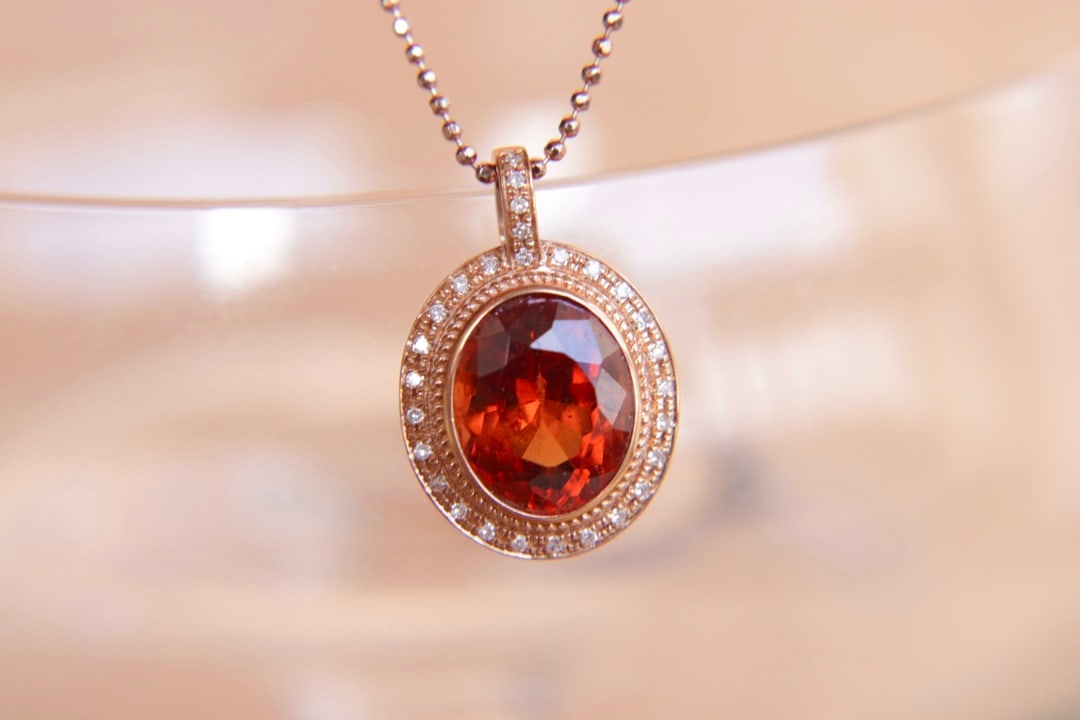 18K Gold Natural Fanta Garnet Pendant: Title: 18K Gold Natural Fanta Garnet Pendant Description: This pendant features a natural Fanta garnet, crafted in 18K gold, with the main stone weighing 3.55 carats. It exudes a rich golden hue and