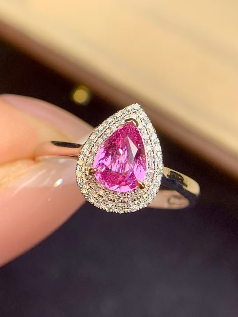 18K Gold Padparadscha Sapphire Ring: Title: 18K Gold Padparadscha Sapphire Ring Description: This ring is crafted in 18K gold, featuring a natural Padparadscha sapphire with a rich golden and cool white hue, weighing 0.88 carats. Complem
