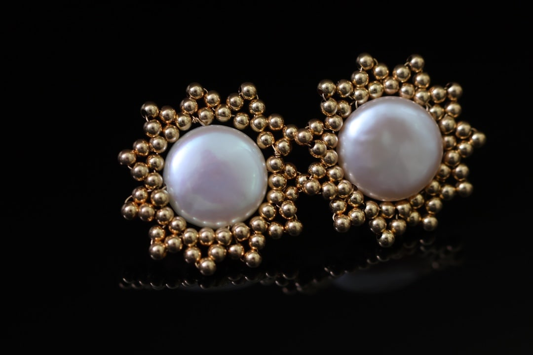 Natural Button Pearl Earrings: Title: Natural Button Pearl Earrings Description: These earrings are set with natural aurora button pearls, radiating a captivating iridescent sheen. The pearls, meticulously handcrafted by artisans,