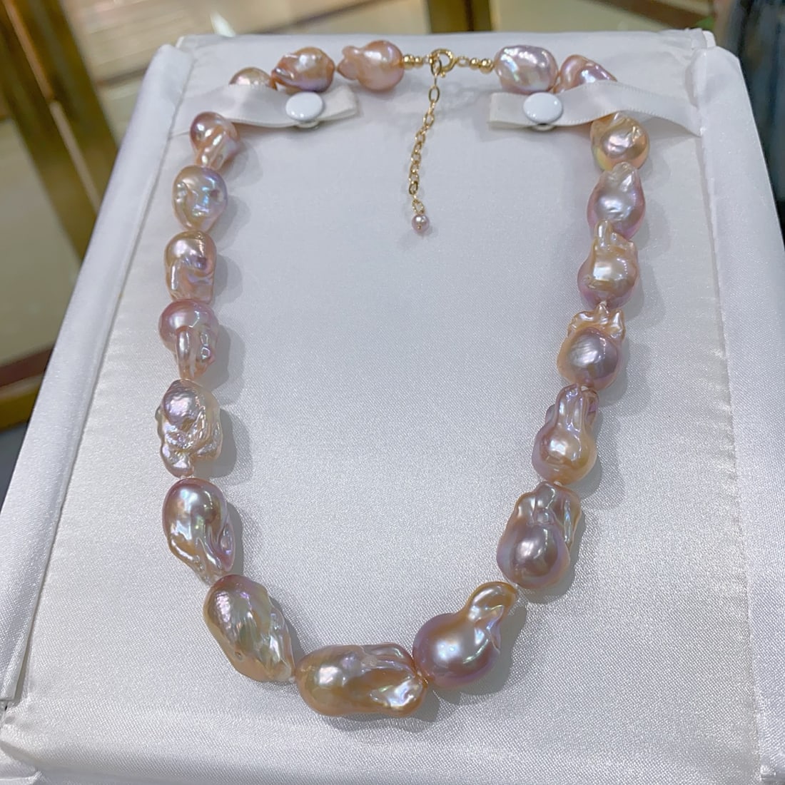Natural Baroque Pearl Necklace: Title: Natural Baroque Pearl Necklace Description: This natural Baroque pearl necklace showcases a rich golden and cool white natural hue with a highly lustrous finish. Each pearl is uniquely colorful