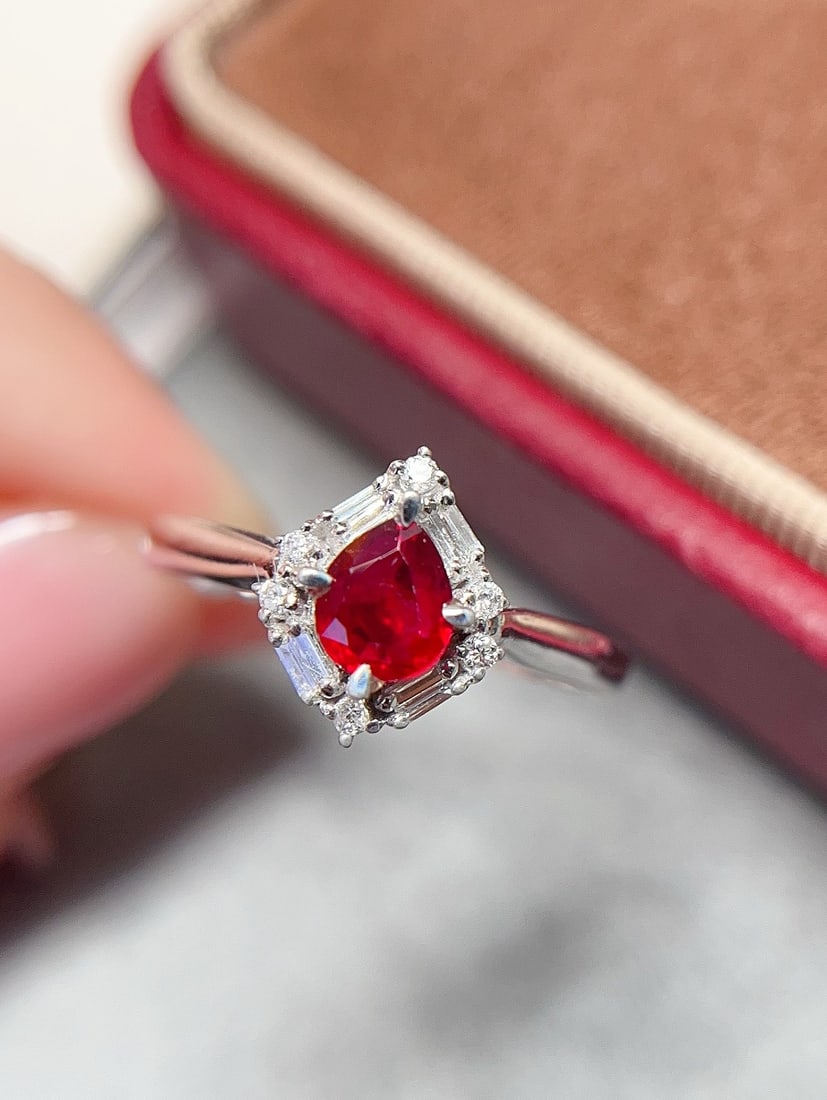 18K Gold Ruby Ring: Title: 18K Gold Ruby Ring Description: This ring features an 18K gold setting with a natural pigeon blood red ruby, showcasing a stunning contrast of rich gold and cool white. The main stone is