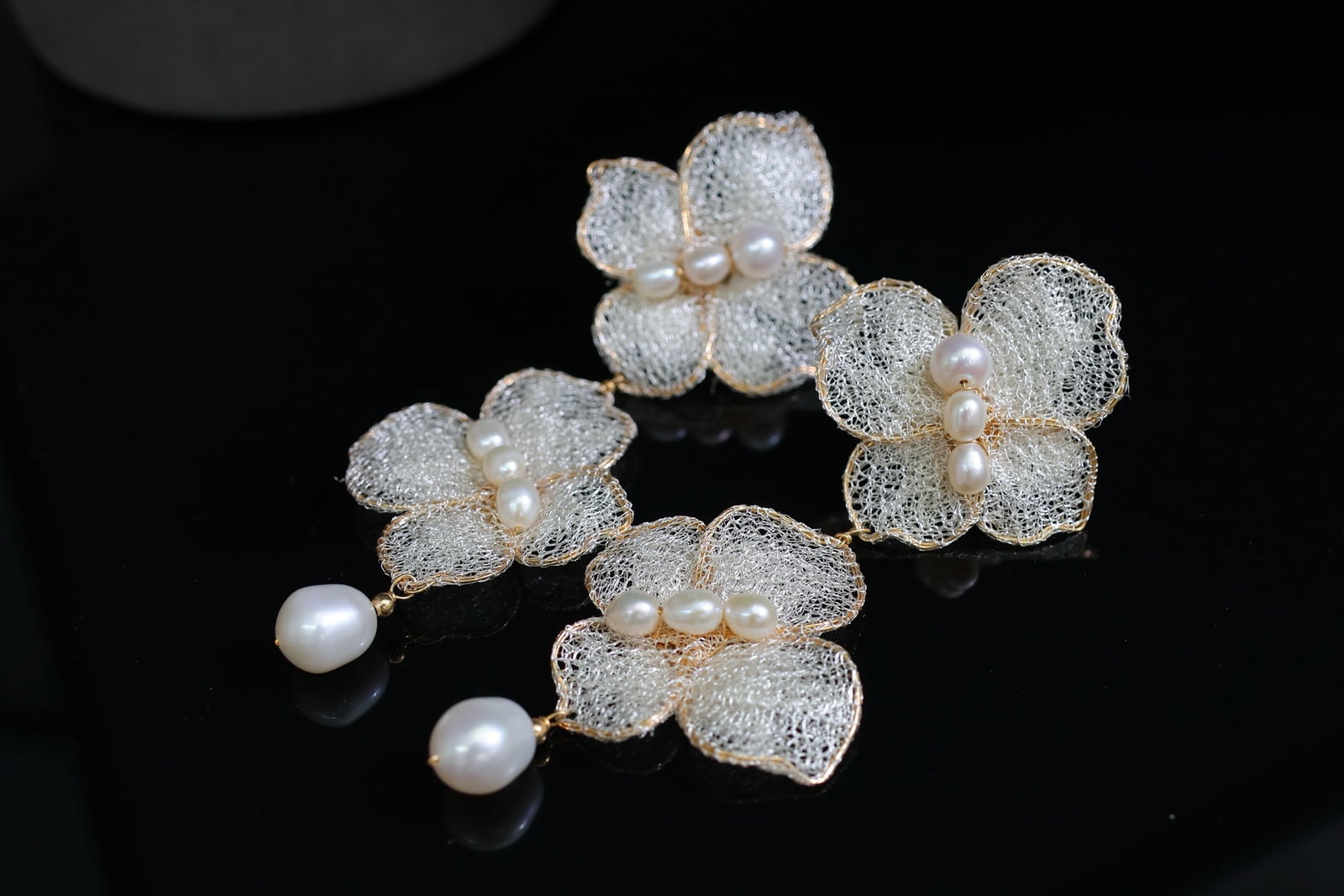 Natural Freshwater Pearl Earrings: Title: Natural Freshwater Pearl Earrings Description: These earrings feature material and natural freshwater pearls, showcasing a rich golden hue and cool white luster. Crafted with Italian lace desig