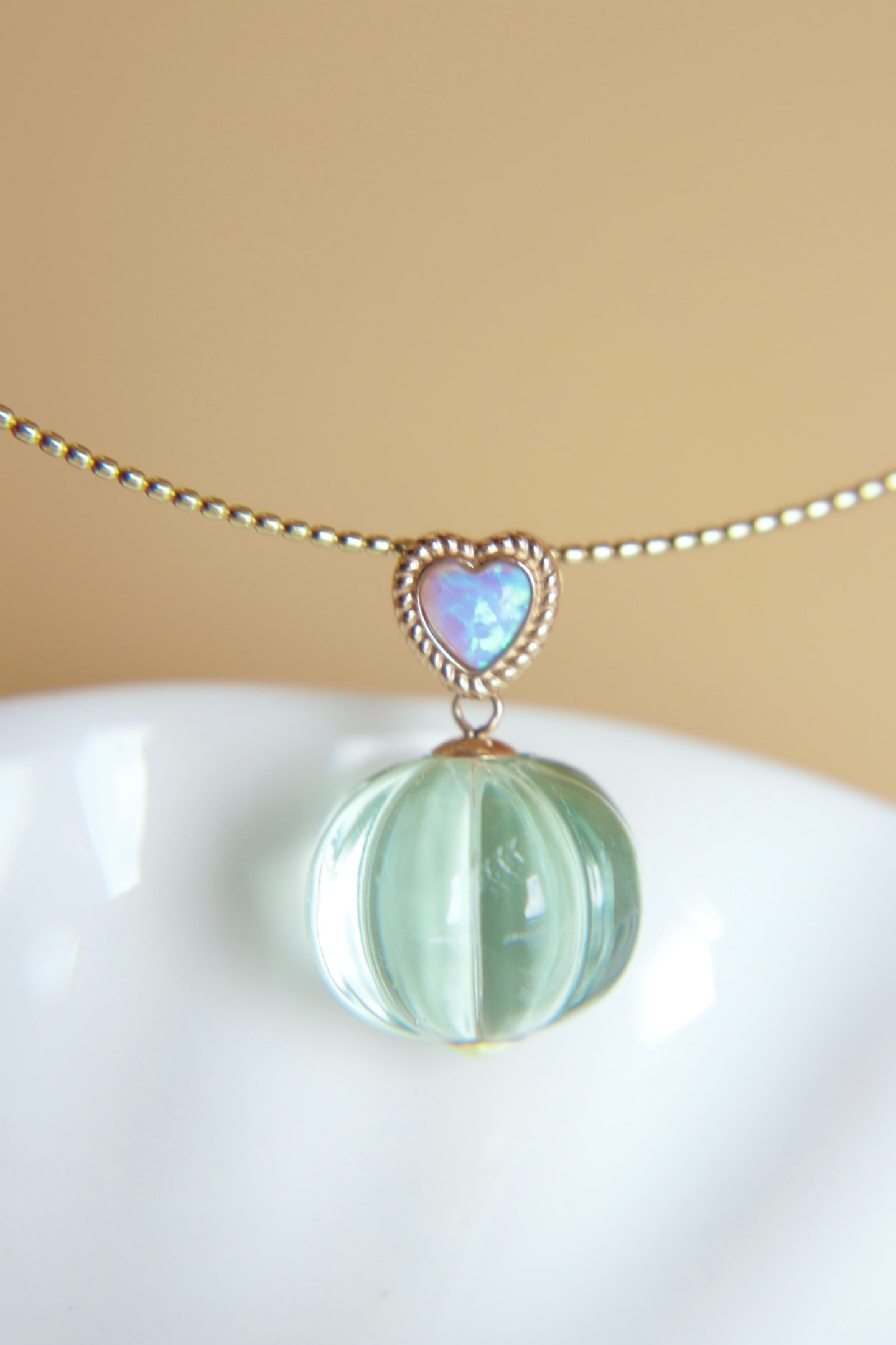 18K Gold Green Amethyst Pendant: Title: 18K Gold Green Amethyst Pendant Description: This pendant features a meticulously set green amethyst in 18K gold, showcasing a cool white luster. Paired with an opal clasp, it boasts vibrant co