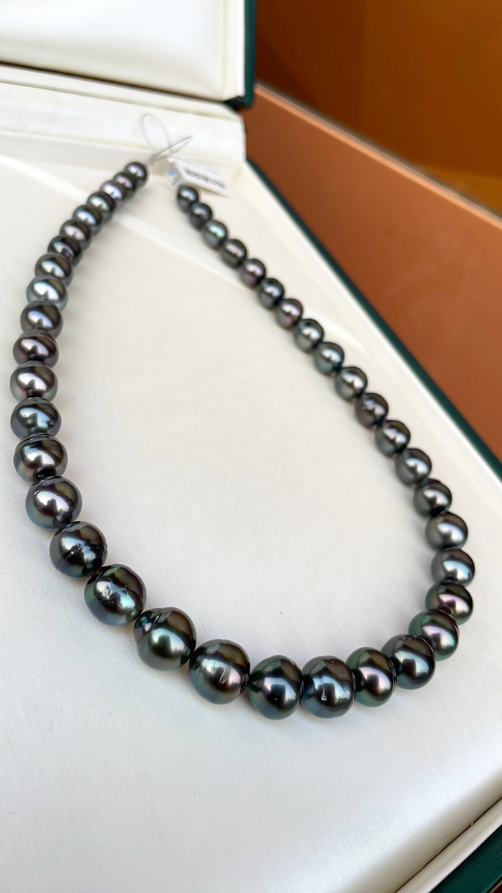 Tahitian Pearl Necklace: Title: Tahitian Pearl Necklace Description: This Tahitian Pearl Necklace showcases a natural rich golden hue and cool white luster. With large diameter, minimal blemishes, and perfect roundness, the